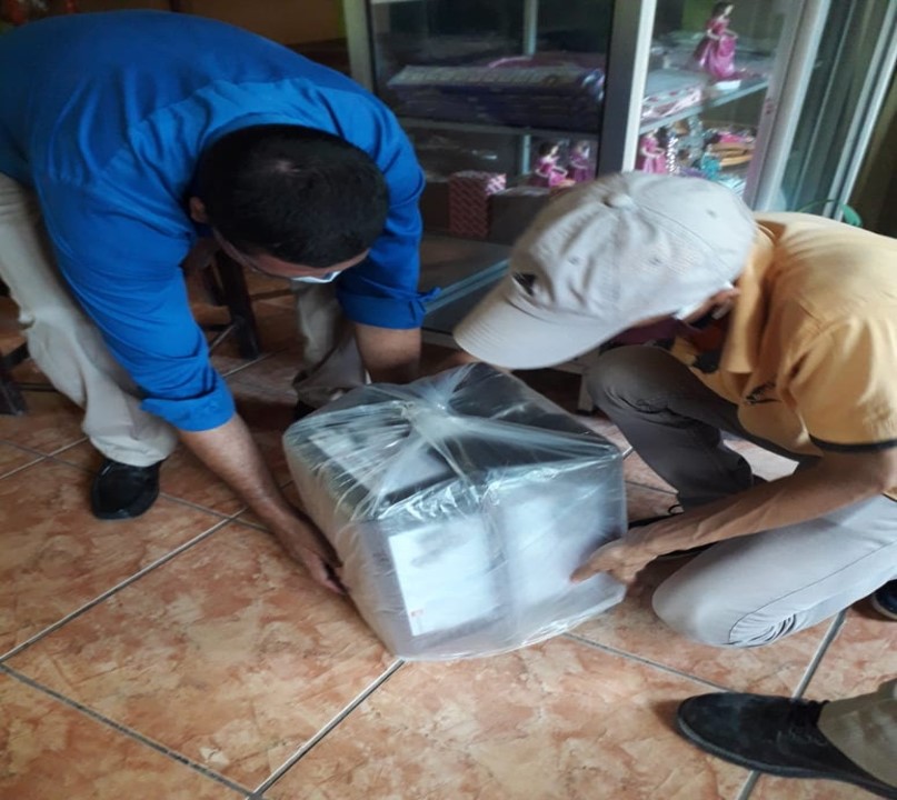 Coaches from Santa Lucia covering the lego kits before being fumigated at the police checkpoint.