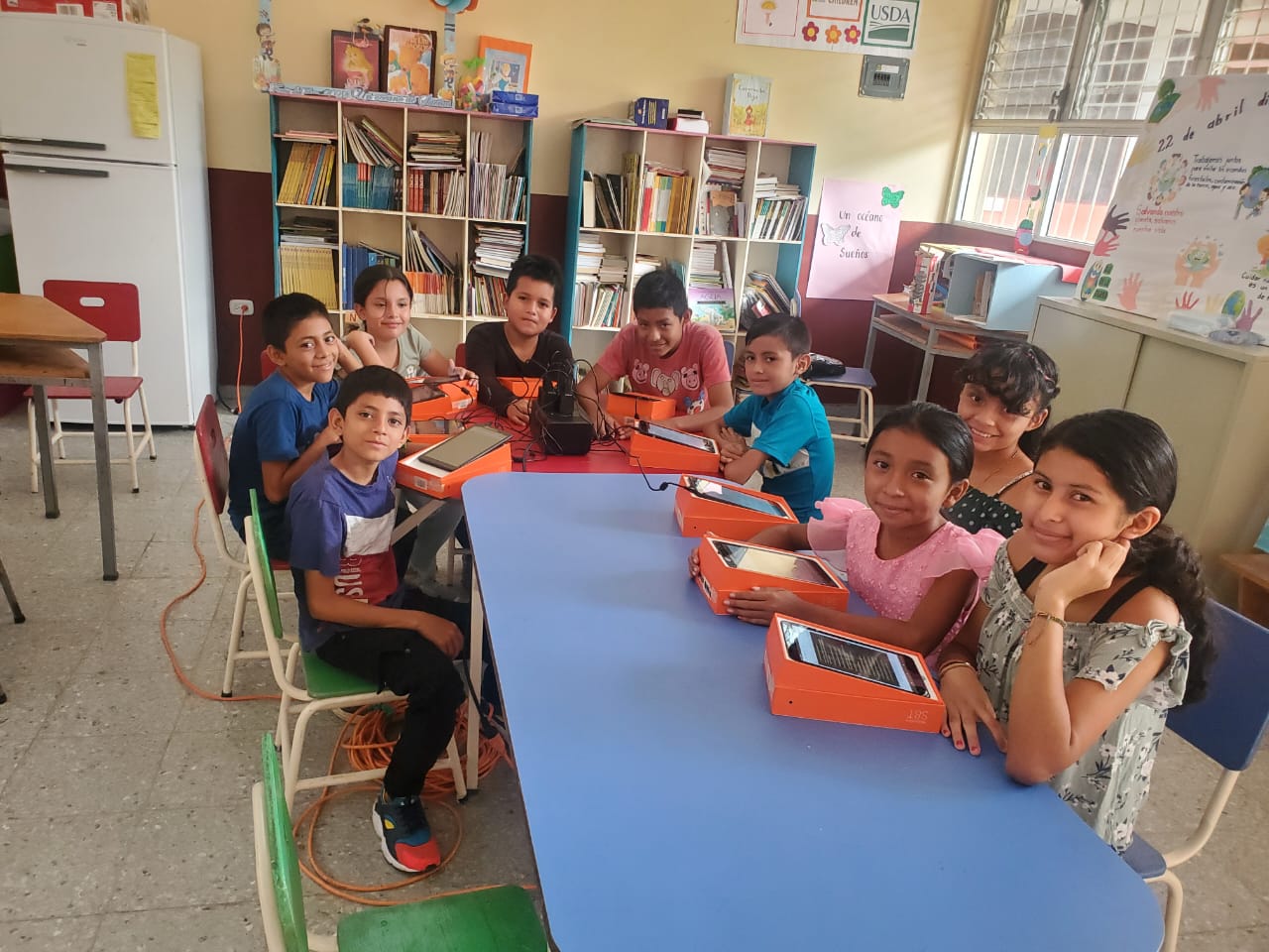 Happy young students reading books in a classroom